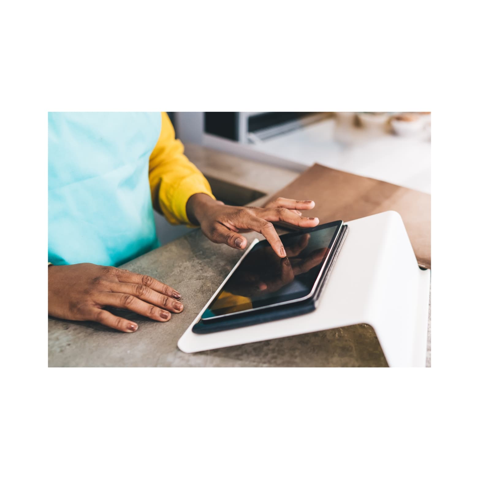 Nuru POS running on a mounted tablet at a service counter